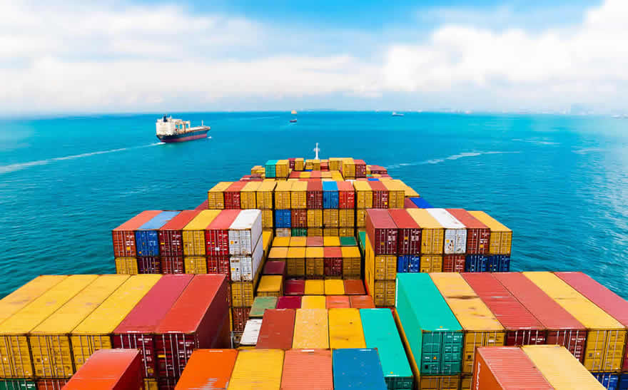 Image: View of a fully loaded cargo ship on the horizon with other ships in the background. © Fotolia