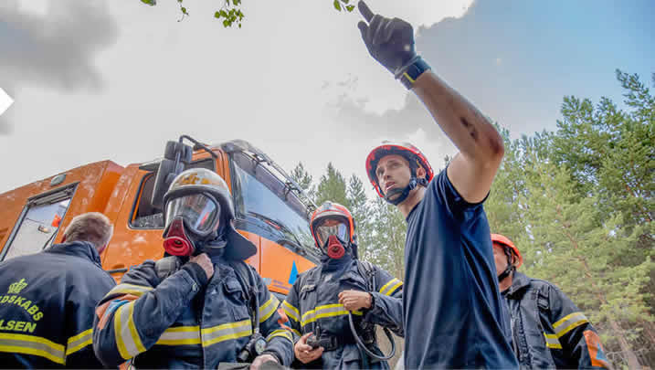 Deense brandweerlieden coördineren hun aanpak tijdens bosbranden in Zweden in de zomer van 2018, toen een beroep werd gedaan op het EU-mechanisme voor civiele bescherming dat de middelen van de lidstaten in dit soort noodsituaties bundelt, Kårböle, Zweden, 22 juli 2018.